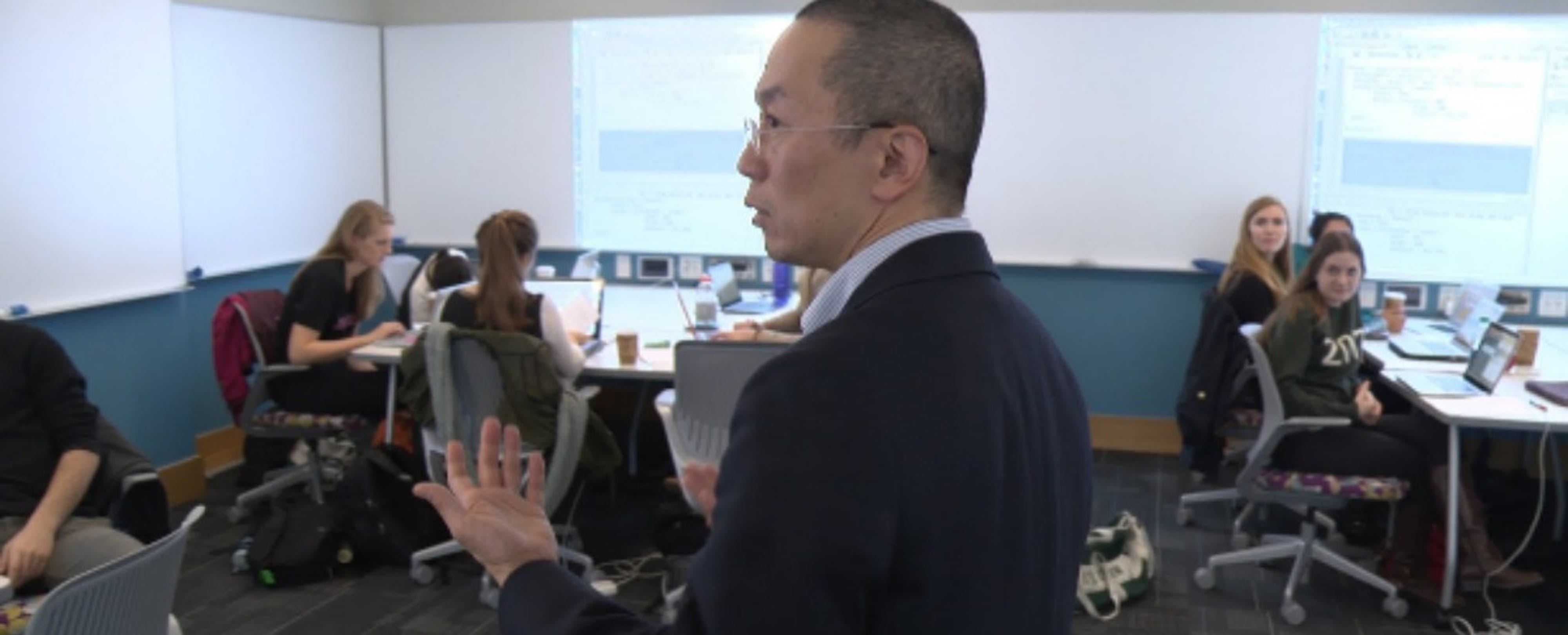 professor teaching from the center of the room